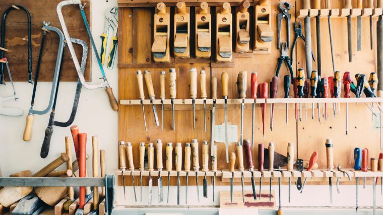 assorted handheld tools in tool rack