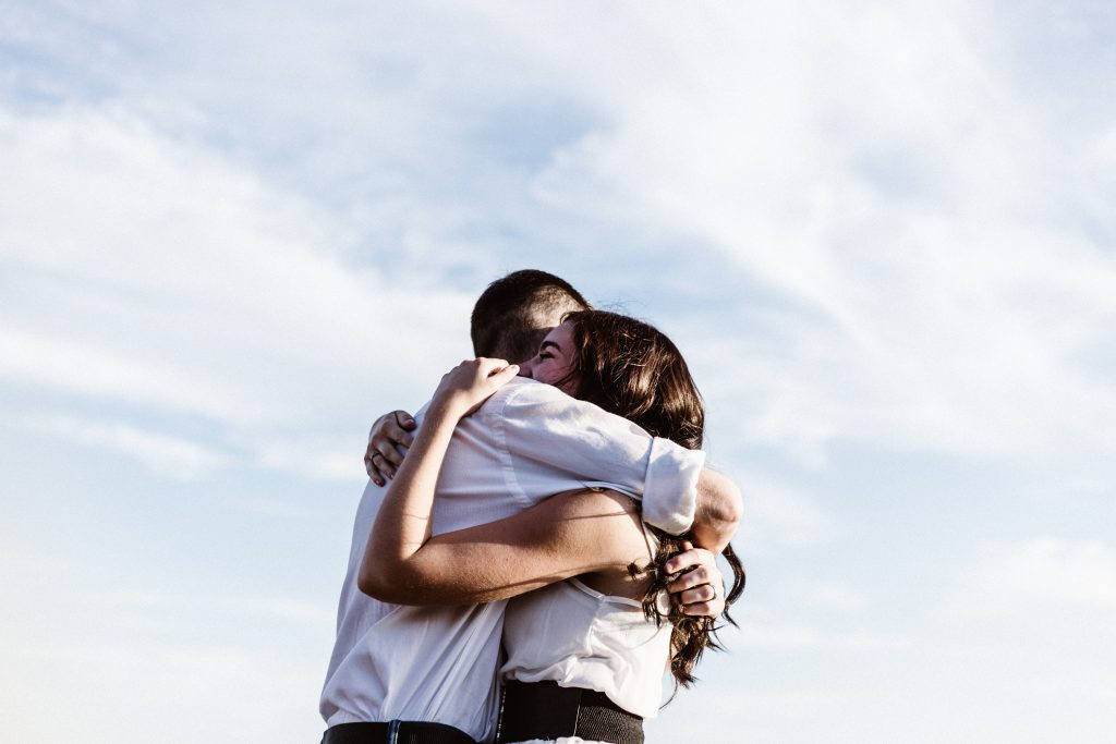 man and woman hugging each other photography