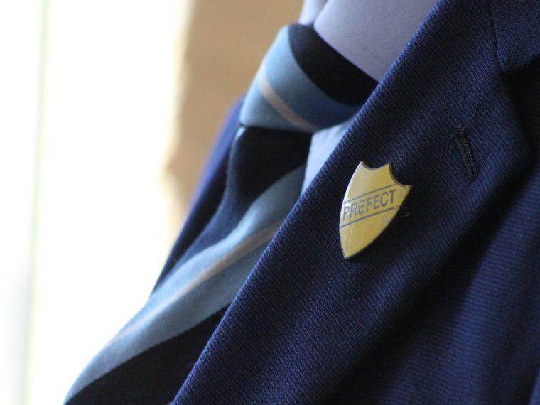 Vintage Prefect badge on old school uniform